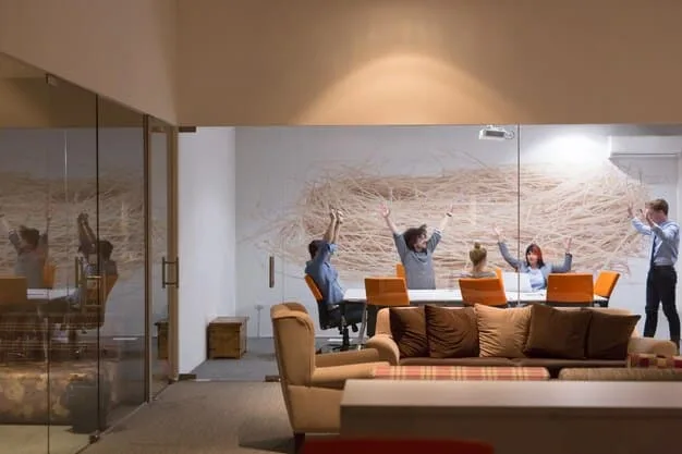 An office interior with a focus on collaboration and modern design, showcasing flexible workspaces, lounge areas, and employees engaged in a meeting, reflecting the changing needs of businesses in the current market.