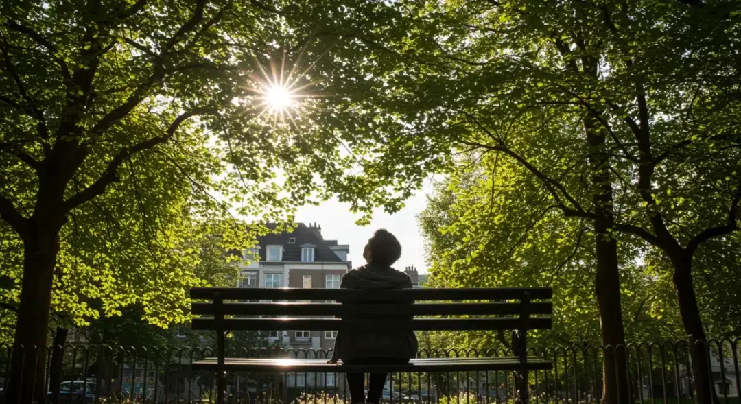 Individual pausing in a park, appreciating the sky and natural surroundings