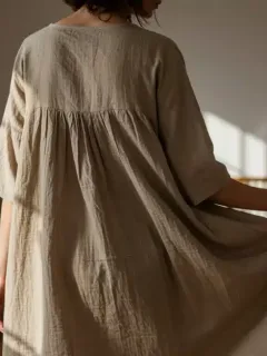 Woman wearing a sustainable fabric dress in a modern, eco-friendly setting