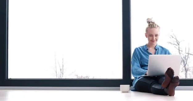 A person using a laptop to compare health insurance plans online. The background is a bright and modern office.