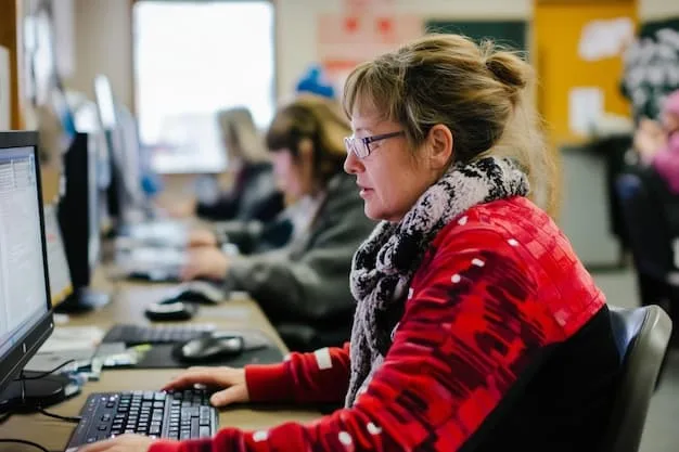 A person participates in a coding bootcamp. Focus is on people learning Javascript, HTML, and CSS in a classroom setting.