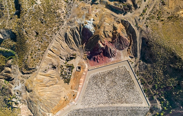 A satellite image of the Natanz nuclear facility in Iran. The image is taken from a high angle, showing the layout of the facility with its various buildings and structures. The surrounding desert landscape is visible, highlighting the isolation of the site.