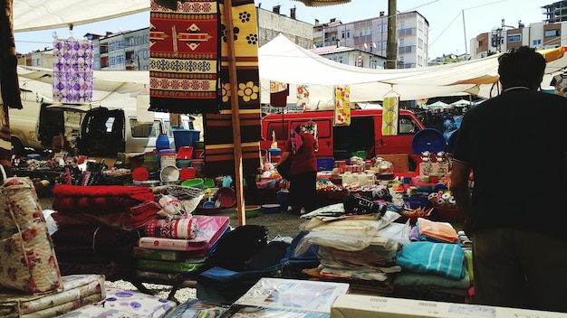 A bustling marketplace scene in Kabul, focusing on local vendors selling goods, with a backdrop of daily life and economic activity, symbolizing the resilience and challenges facing Afghan businesses and consumers.