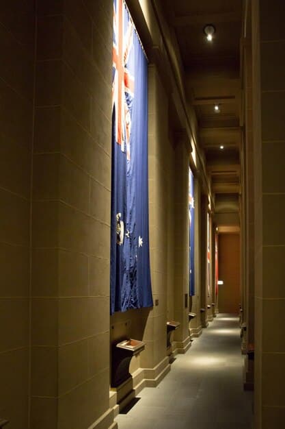 A dimly lit interior of the Federal Reserve Building in Washington, D.C., with focus on the architecture and official seals.