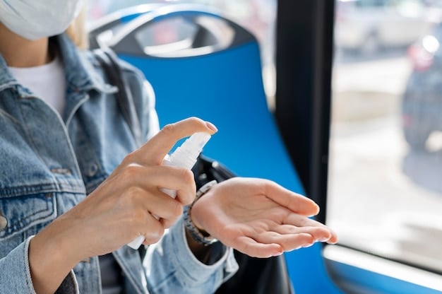 A person wearing a face mask and using hand sanitizer in a public transportation setting.
