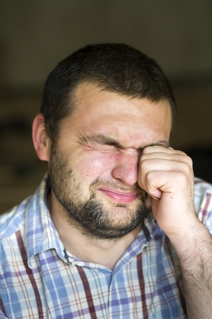 A close-up of a person's face showing signs of stress and exhaustion, such as furrowed brow and tired eyes. The image has muted colors to convey the feeling of overwhelm.