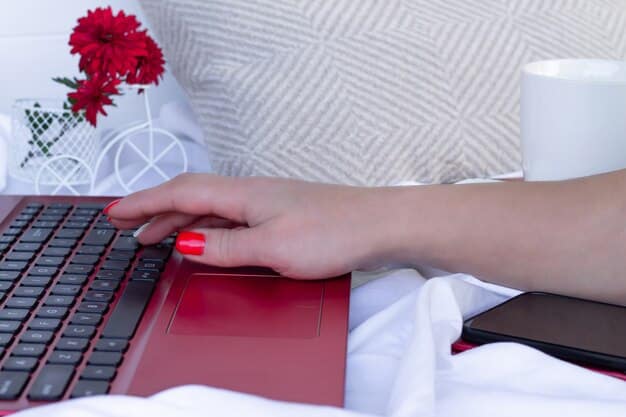 A close-up shot of a person's hands typing on a laptop keyboard. The background is blurred, suggesting a busy home environment. The focus is on the hands and keyboard, symbolizing the act of remote work and digital productivity.
