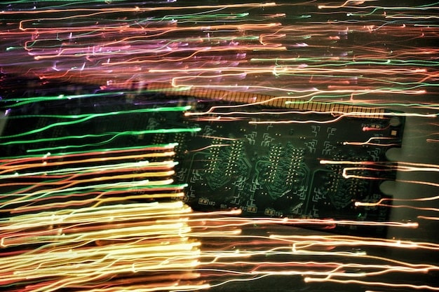 A close-up of a circuit board with exposed wires, representing the hardware vulnerabilities of IoT devices, overlaid with digital glitch effects to signify cyberattacks.