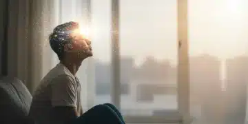 Person visualizing future goals with serene expression, light around their head.