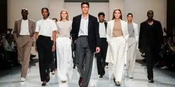 Models showcasing modern gender-neutral fashion on a runway.